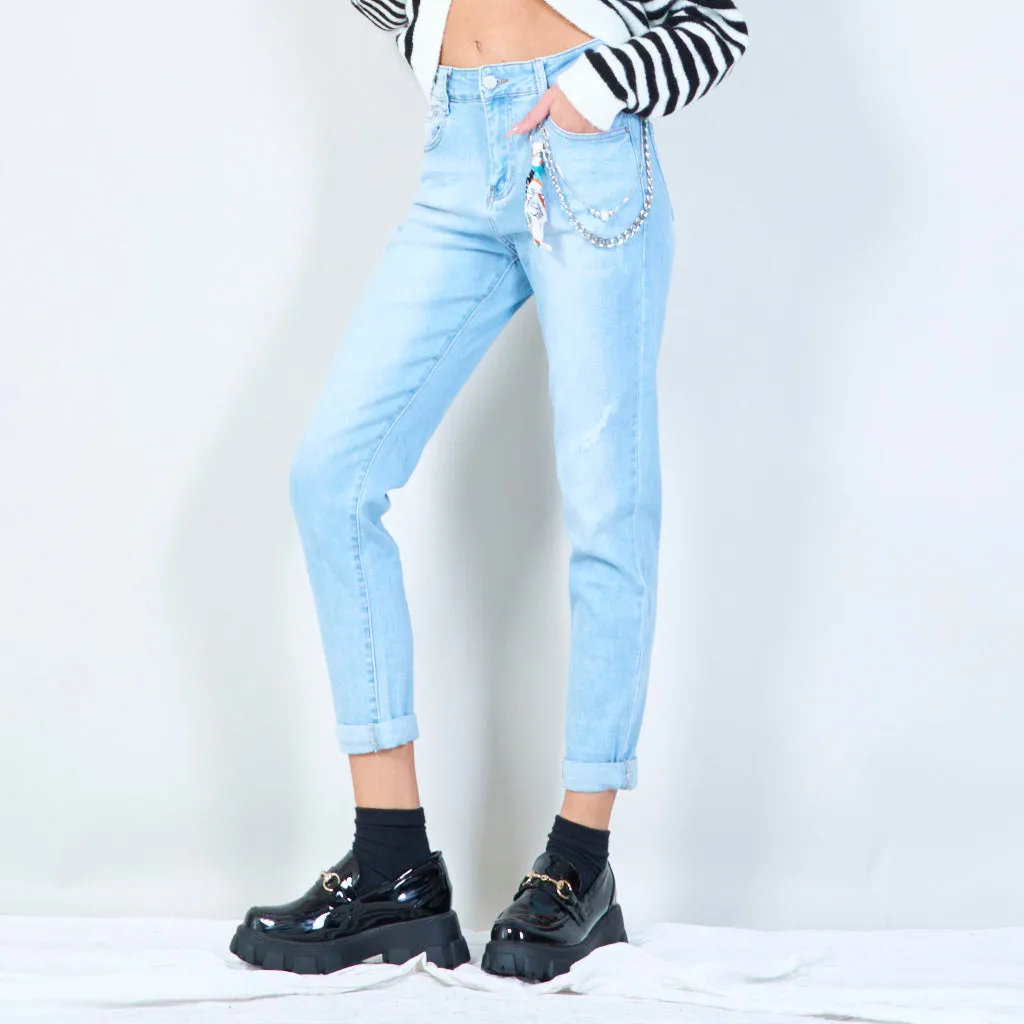 Distressed denim jeans with chain accessory wholesale